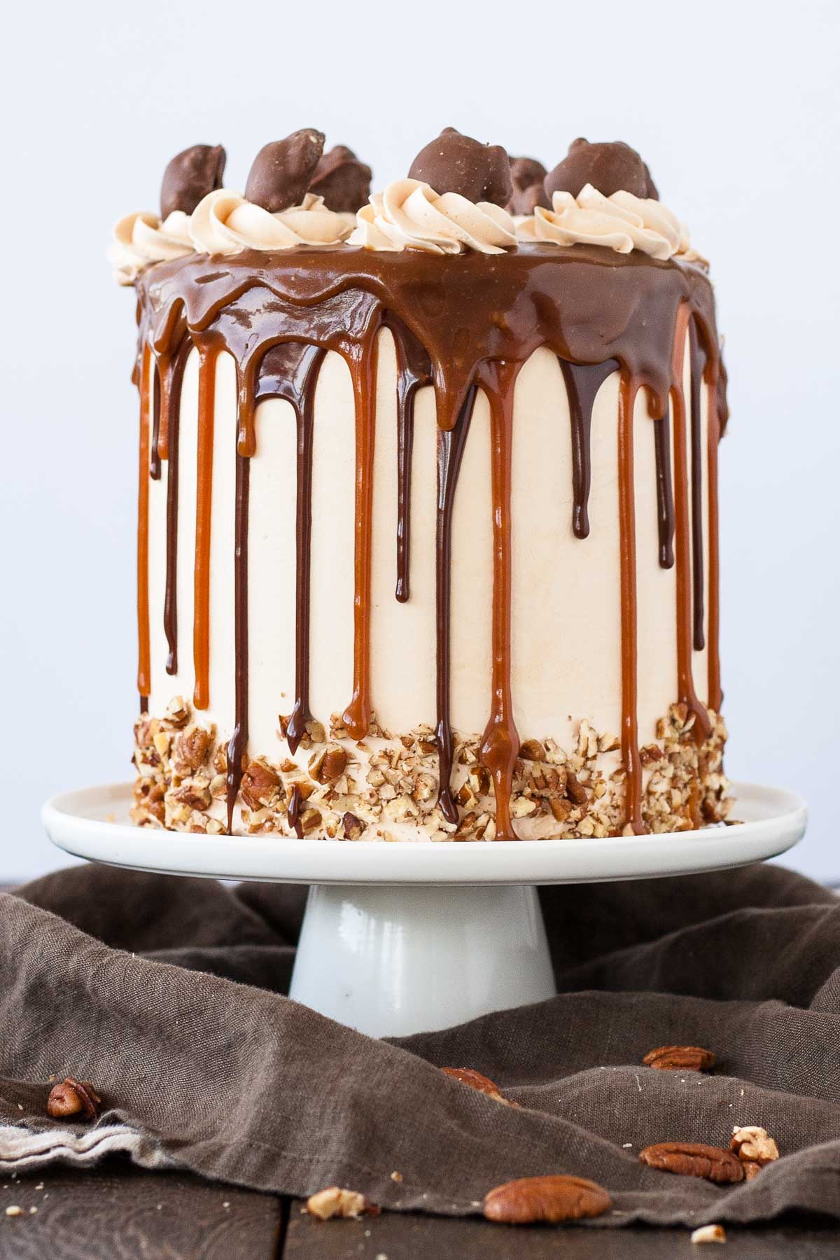 A cake sitting on top of a white cake stand.