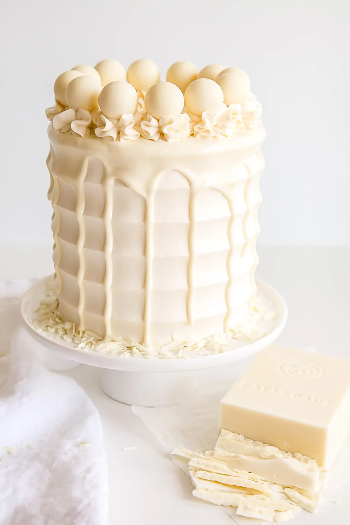 White Chocolate Cake with a chopped up bar of white chocolate on the side.