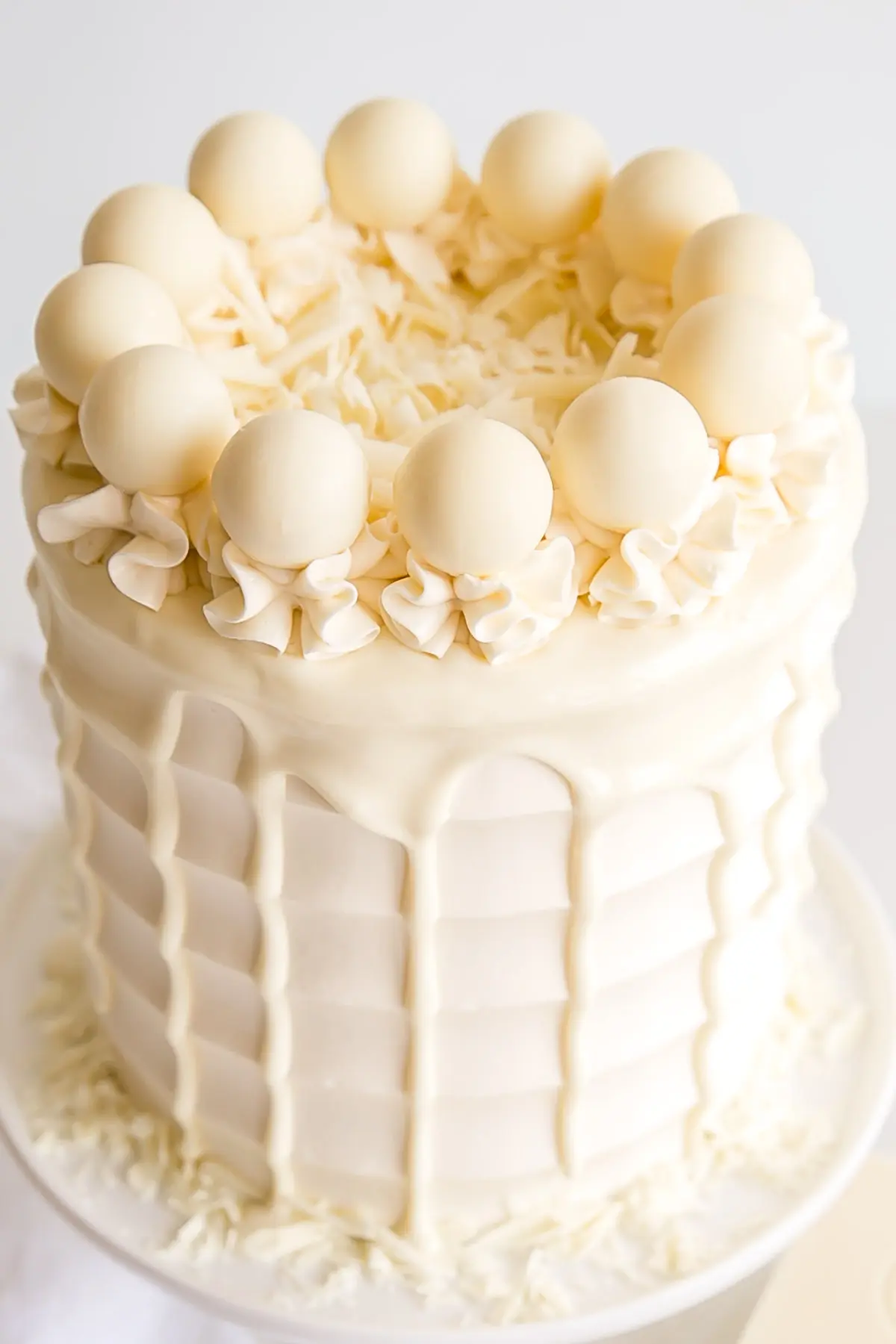 Angled overhead shot showing the drip and white chocolate truffles.